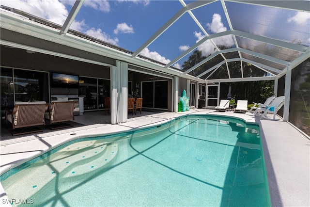 outdoor pool featuring a lanai and a patio