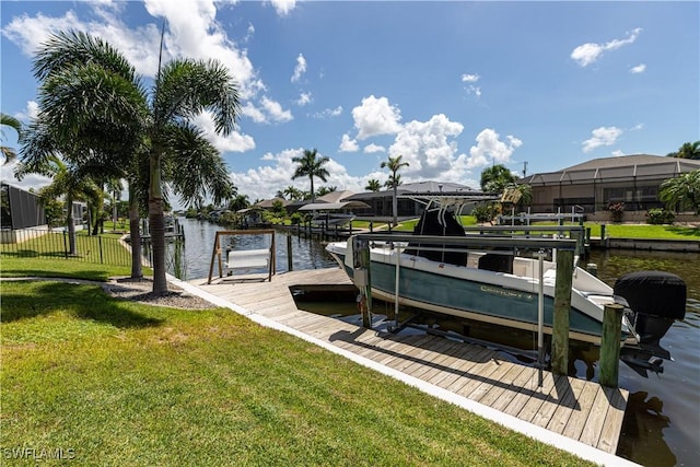 dock area featuring a water view, boat lift, and a lawn