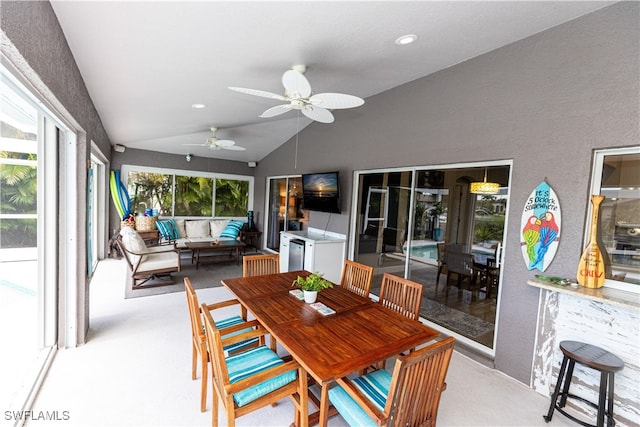 sunroom / solarium with lofted ceiling and a ceiling fan