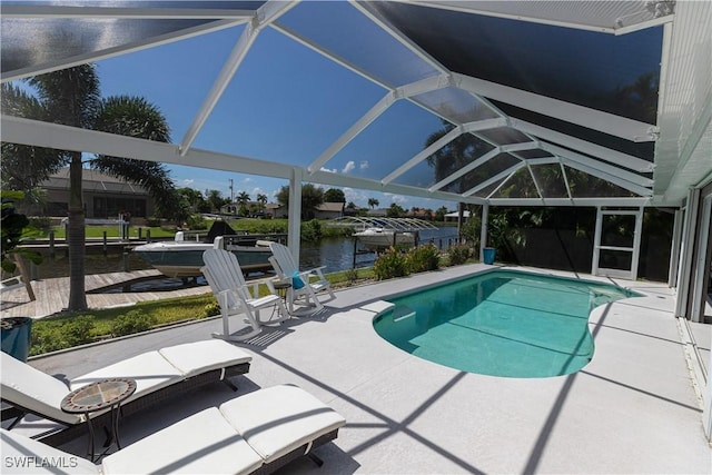 pool featuring a patio area, a lanai, and a water view