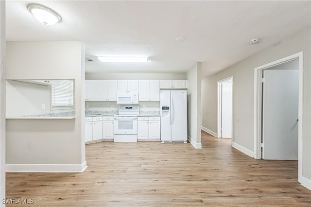 kitchen with light hardwood / wood-style flooring, white appliances, and white cabinets