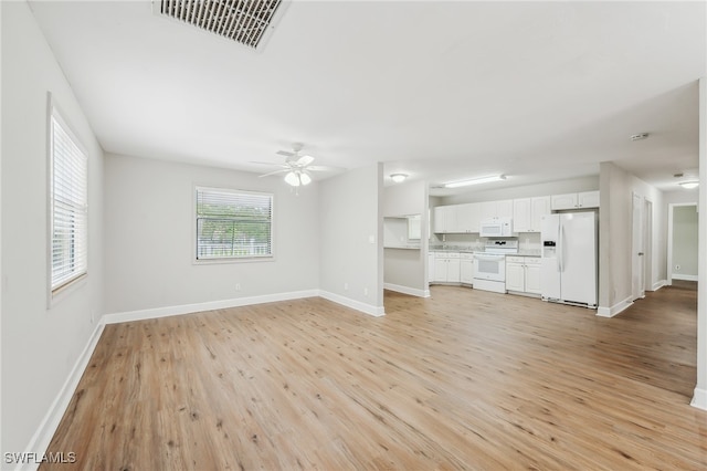 unfurnished living room with light hardwood / wood-style flooring and ceiling fan