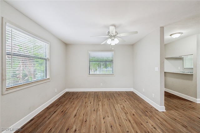 spare room with hardwood / wood-style flooring and ceiling fan