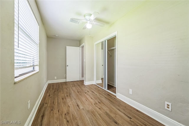 unfurnished bedroom with ceiling fan, a closet, and light hardwood / wood-style floors