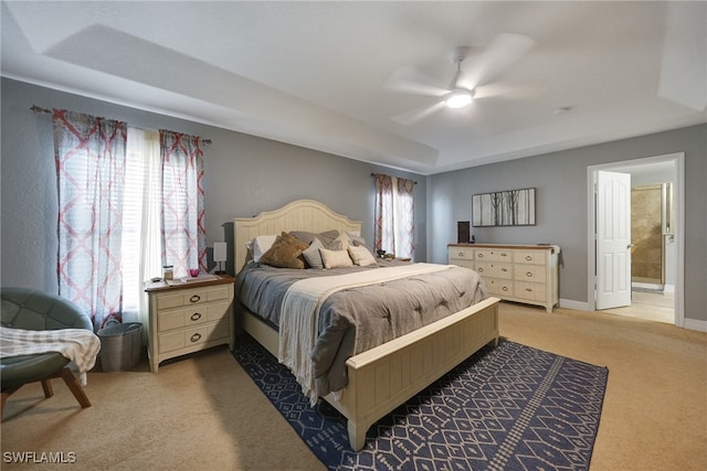 carpeted bedroom featuring ensuite bath and ceiling fan