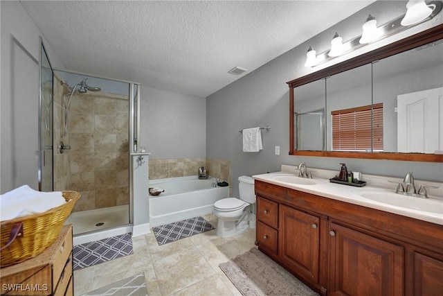 full bathroom with vanity, tile patterned floors, toilet, a textured ceiling, and independent shower and bath