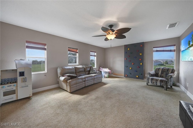 living room featuring carpet and ceiling fan