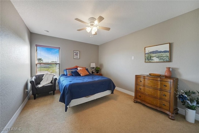 bedroom with light carpet and ceiling fan