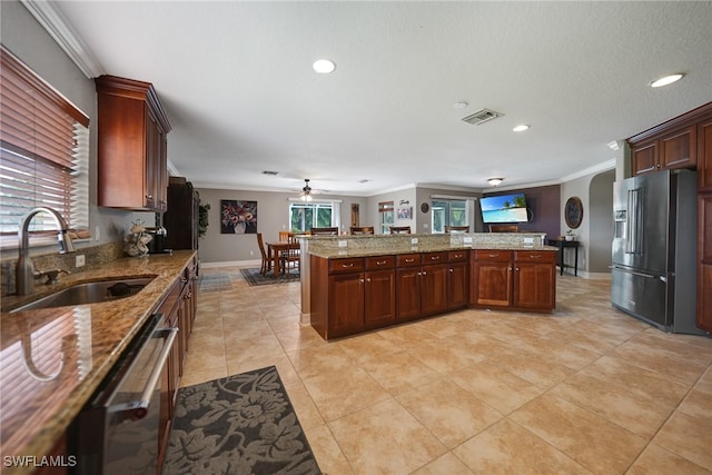 kitchen with crown molding, sink, ceiling fan, light stone countertops, and appliances with stainless steel finishes