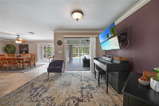 interior space featuring a textured ceiling, ceiling fan, and crown molding