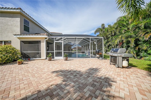 rear view of property with a patio and a lanai