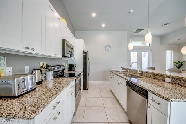 kitchen featuring visible vents, appliances with stainless steel finishes, a sink, and light tile patterned flooring