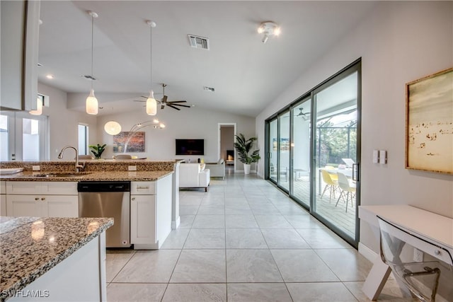 kitchen with visible vents, white cabinetry, a sink, light stone countertops, and dishwasher