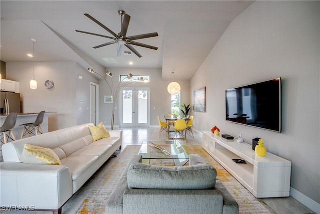 living room with recessed lighting, a ceiling fan, baseboards, vaulted ceiling, and french doors