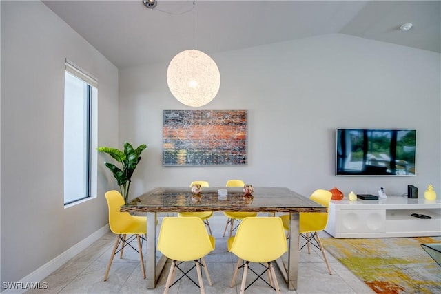 tiled dining room featuring vaulted ceiling, baseboards, and a healthy amount of sunlight