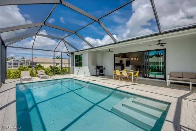 pool with a ceiling fan, glass enclosure, and a patio