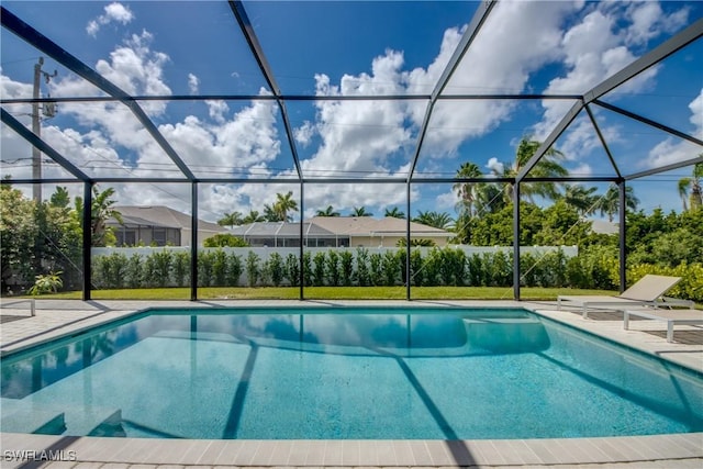 pool featuring glass enclosure and a patio area