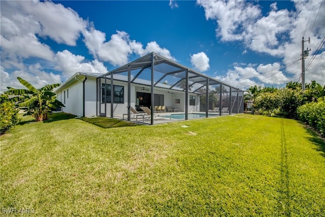 back of house with an outdoor pool, a lawn, a patio, a lanai, and stucco siding