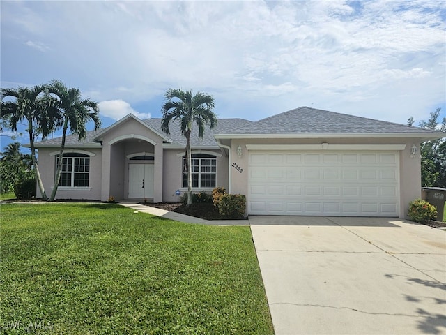 single story home with a front yard and a garage