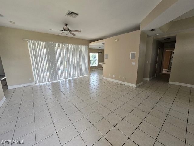 unfurnished living room featuring light tile patterned floors and ceiling fan