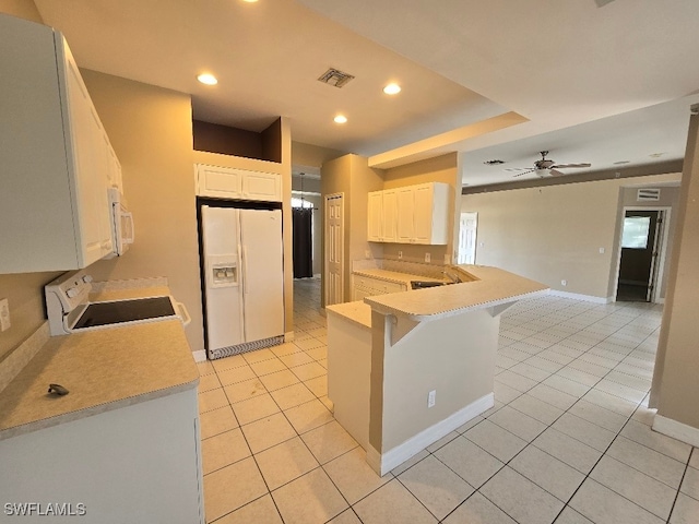 kitchen with white appliances, kitchen peninsula, ceiling fan, a breakfast bar, and white cabinets