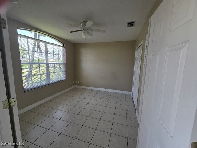 interior space with light tile patterned floors and ceiling fan