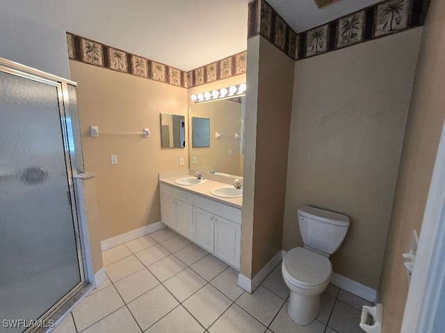 bathroom with vanity, toilet, a shower with shower door, and tile patterned floors