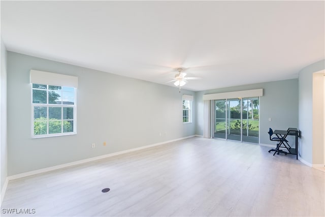 empty room with light wood-type flooring and ceiling fan