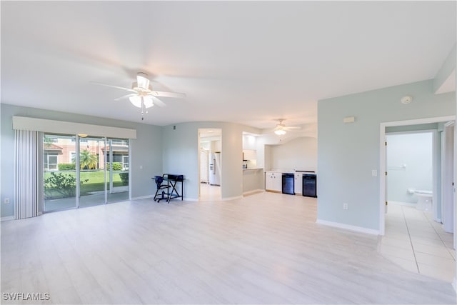 unfurnished living room featuring ceiling fan and light hardwood / wood-style floors