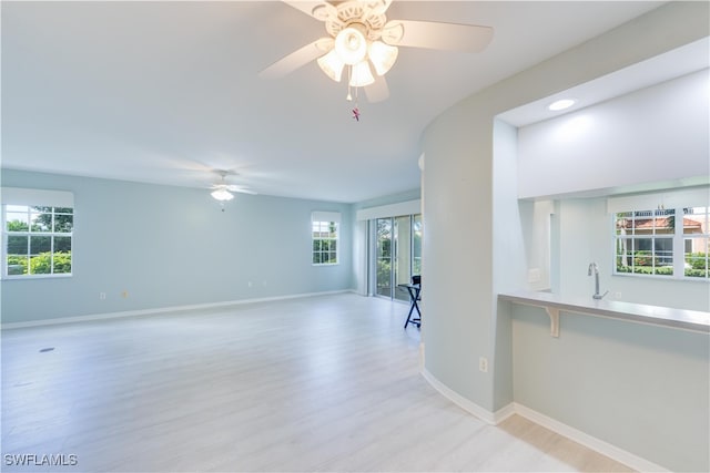 unfurnished room featuring light hardwood / wood-style flooring and ceiling fan