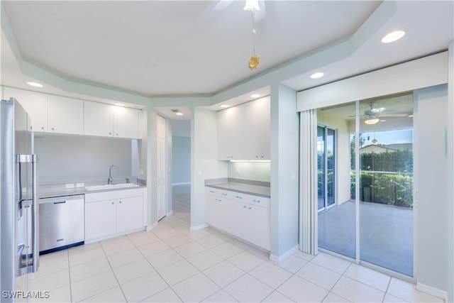 kitchen featuring ceiling fan, sink, stainless steel appliances, and white cabinetry