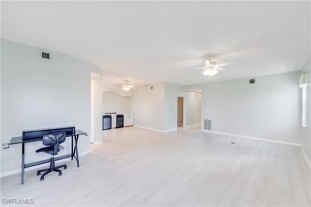 living room with ceiling fan and light wood-type flooring