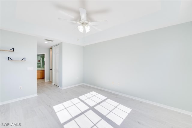 unfurnished room with ceiling fan and light wood-type flooring