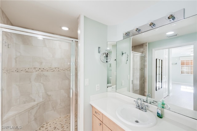 bathroom featuring an enclosed shower and vanity