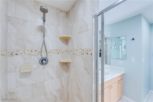 bathroom featuring vanity and tiled shower