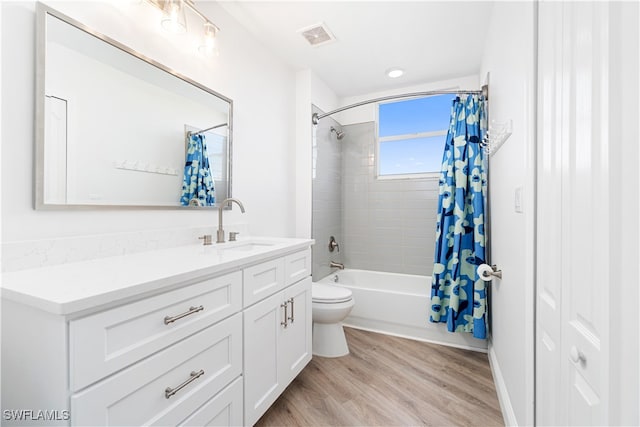 full bathroom with shower / bath combo, wood-type flooring, toilet, and vanity