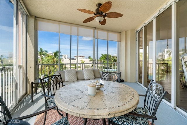 sunroom featuring a healthy amount of sunlight and ceiling fan