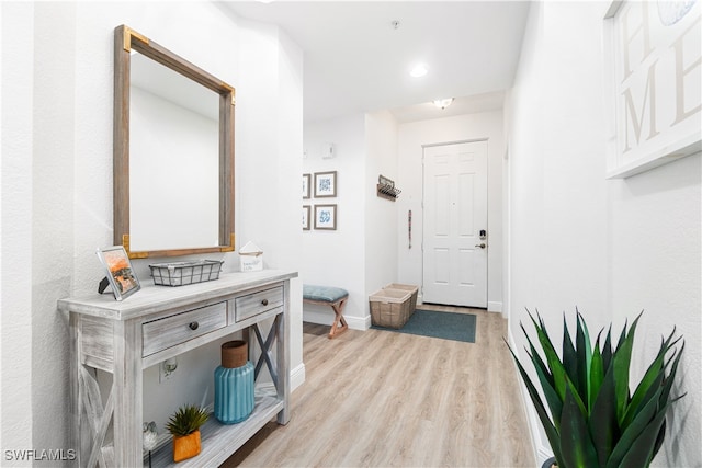 corridor with light hardwood / wood-style floors