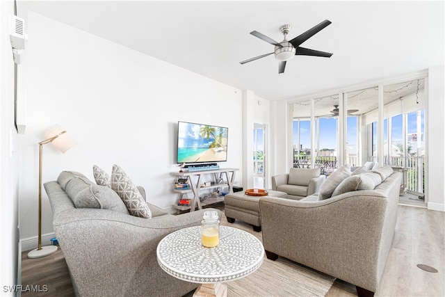 living room featuring ceiling fan and hardwood / wood-style flooring