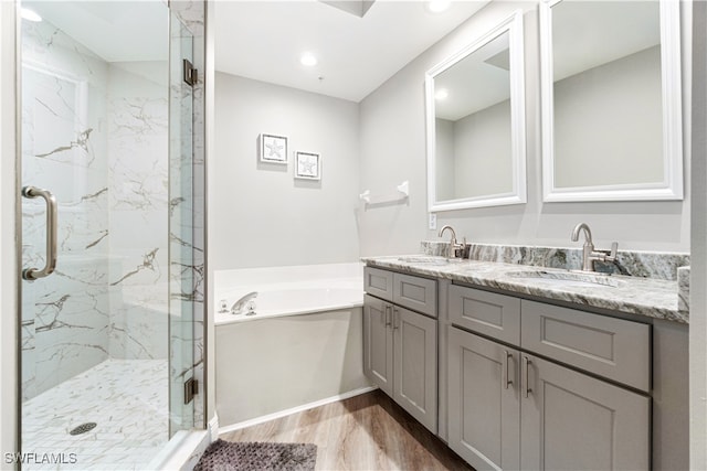 bathroom featuring separate shower and tub, hardwood / wood-style flooring, and vanity