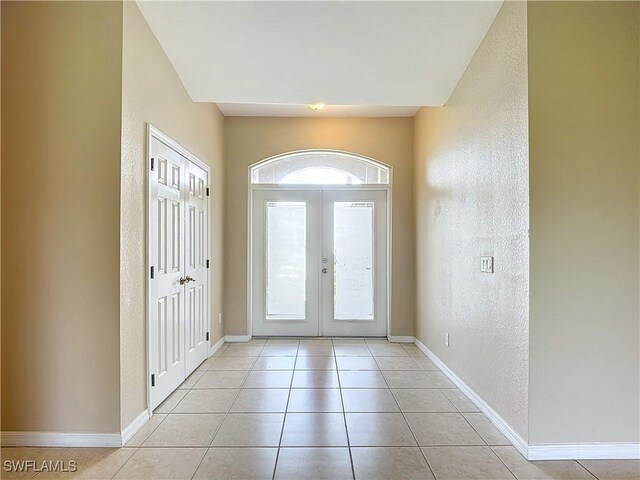 tiled foyer entrance featuring french doors