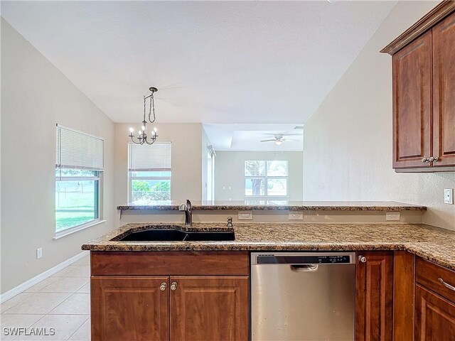 kitchen featuring ceiling fan with notable chandelier, light stone countertops, sink, light tile patterned flooring, and stainless steel dishwasher