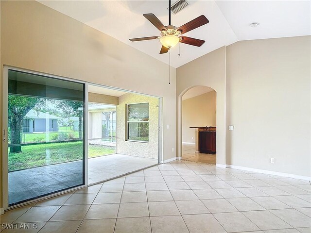 tiled empty room featuring ceiling fan and high vaulted ceiling