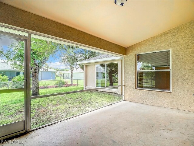 unfurnished sunroom featuring lofted ceiling