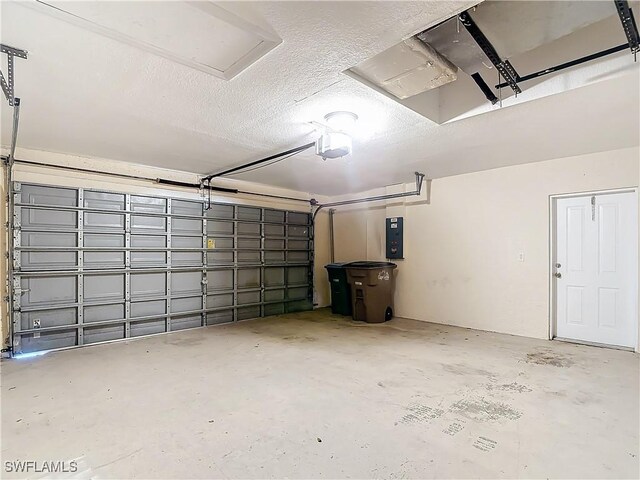 garage featuring a garage door opener and electric panel