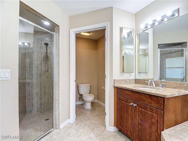 bathroom featuring vanity, toilet, walk in shower, and tile patterned floors