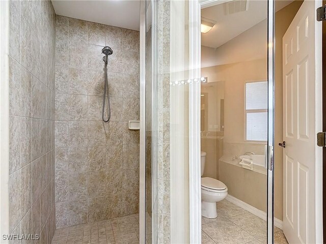 bathroom with separate shower and tub, toilet, and tile patterned floors