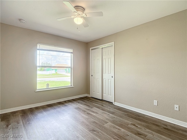 unfurnished bedroom with a closet, ceiling fan, and wood-type flooring