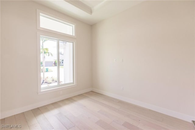 empty room featuring light wood-type flooring and baseboards