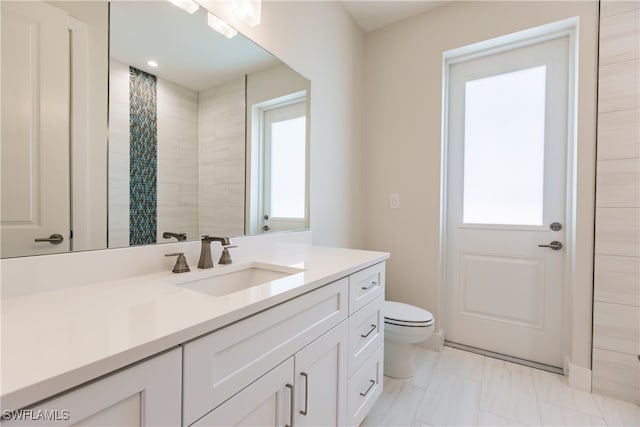 bathroom featuring a wealth of natural light, vanity, toilet, and a shower with shower curtain